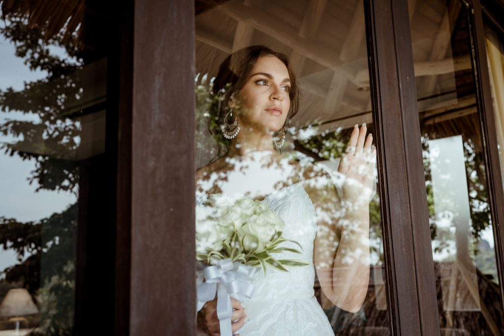 Bride looking through the window before her wedding ceremony at Saii resort Phi Phi Island