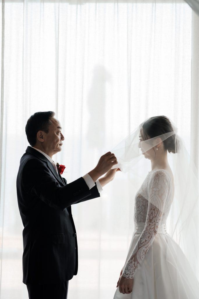 koh Samui wedding photographer captures father putting veil on bride from HK at Silavadee Resort