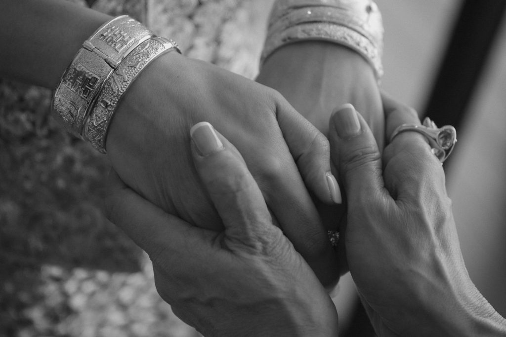 Hong Kong bride holding mothers hands at destination wedding in Phuket
