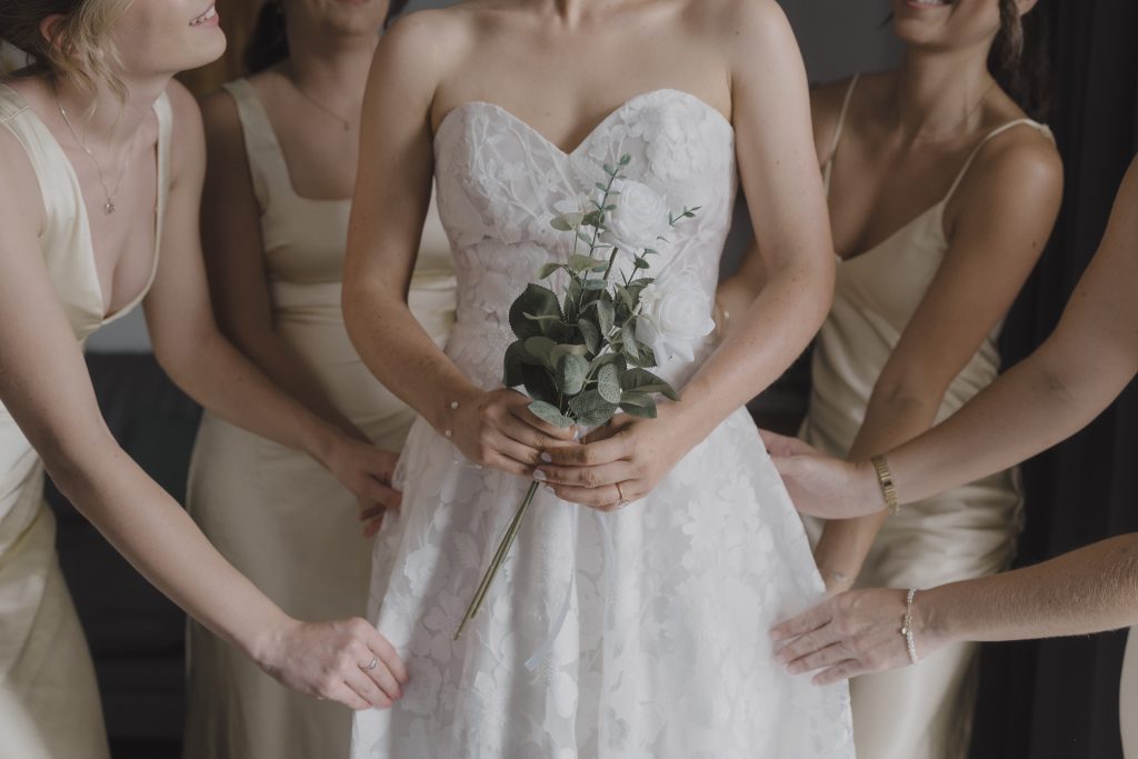 photographer in Koh samui Bride and bridesmaids from UK help bride with her dress. Captured by Samui wedding photographer - Daniel Baci