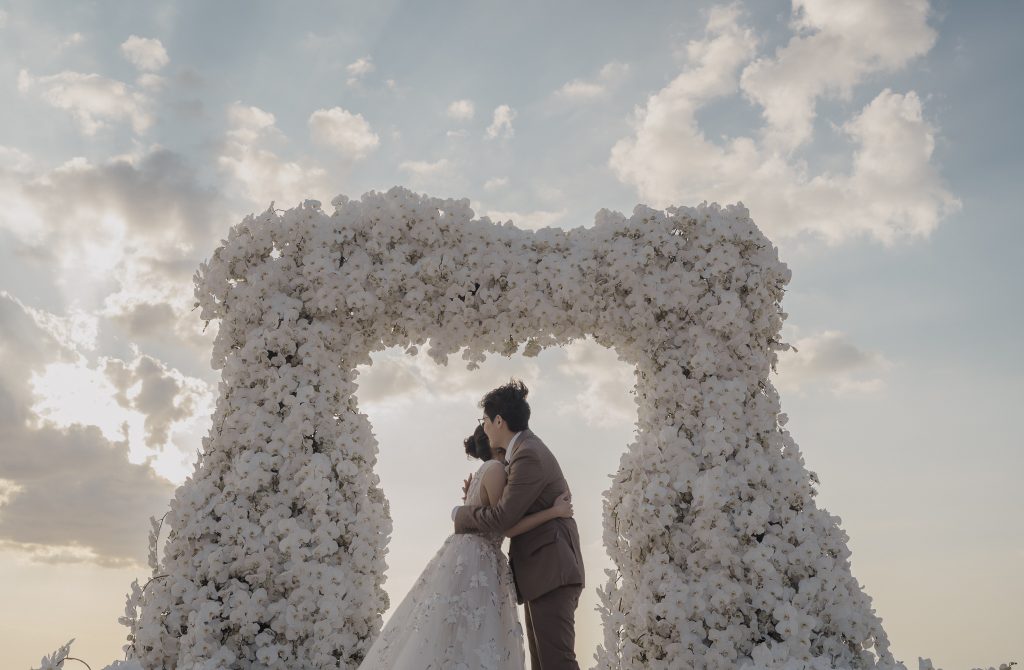 Luxury villa wedding ceremony in Phuket as LGBTQ couple embrace. Phuket wedding photography by Daniel