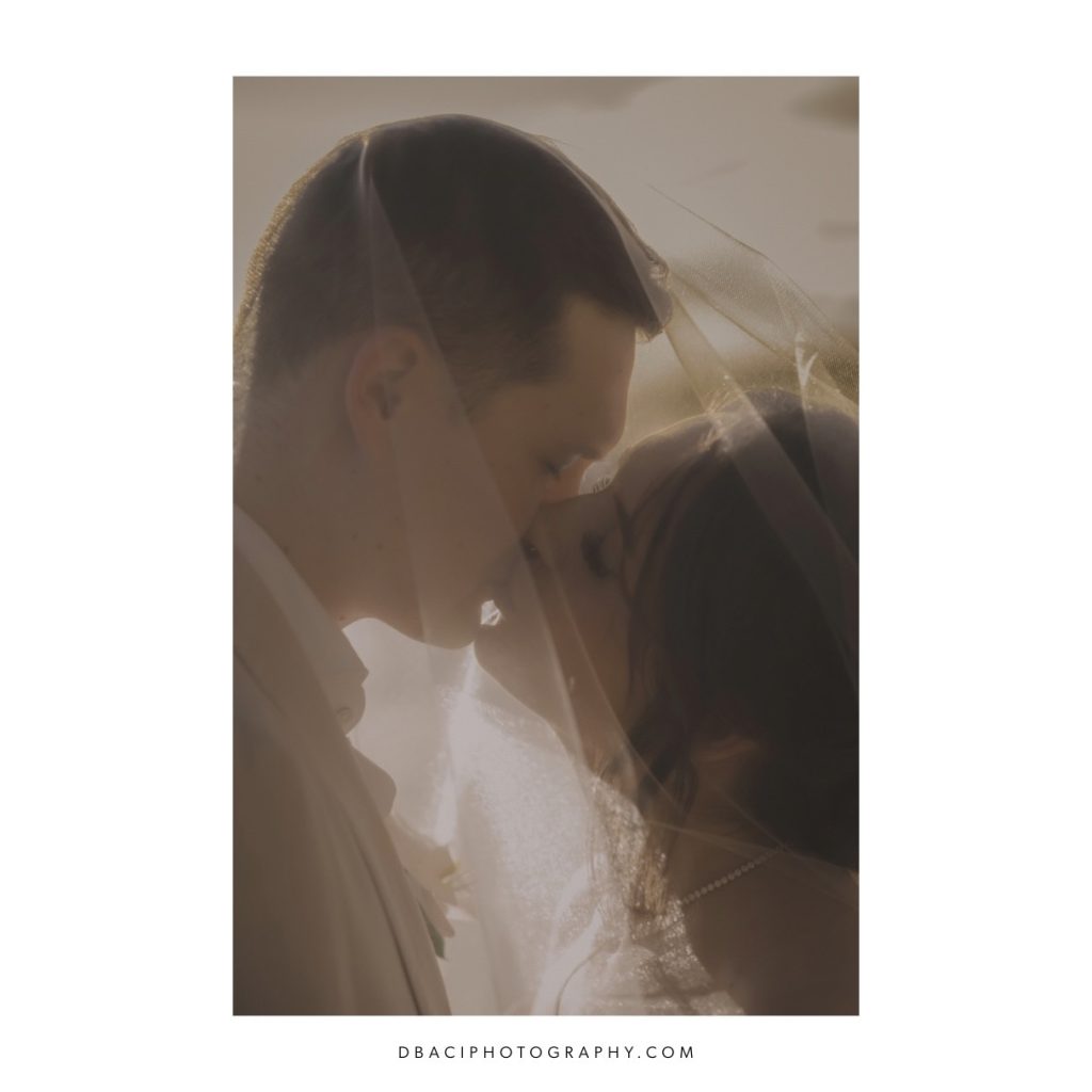 wedding portrait of the bride and groom kissing at sunset at the Rayavadee resort in Krabi
