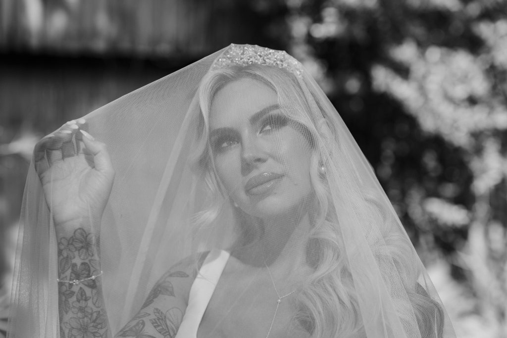 Bride from the UK poses under veil at her destination wedding in Thailand. Photography by Thailand wedding photographer, Daniel Baci