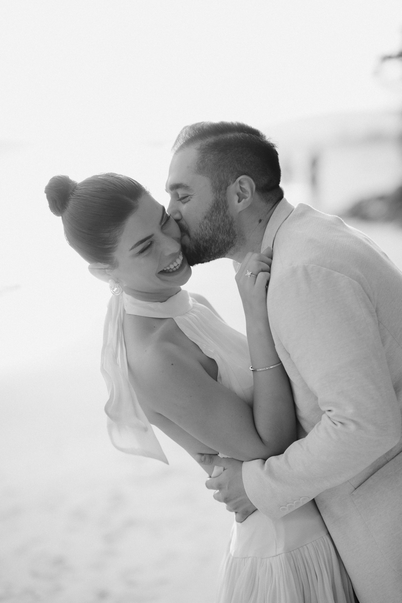 Candid portrait of bride and groom on the beach in Thailand