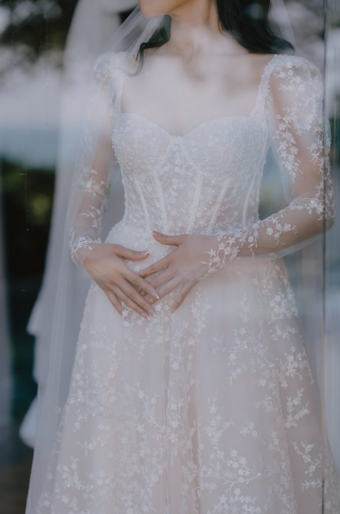 Hong Kong brides portrait through a glass sliding door at their Luxury destination wedding in Koh Samui Thailand.