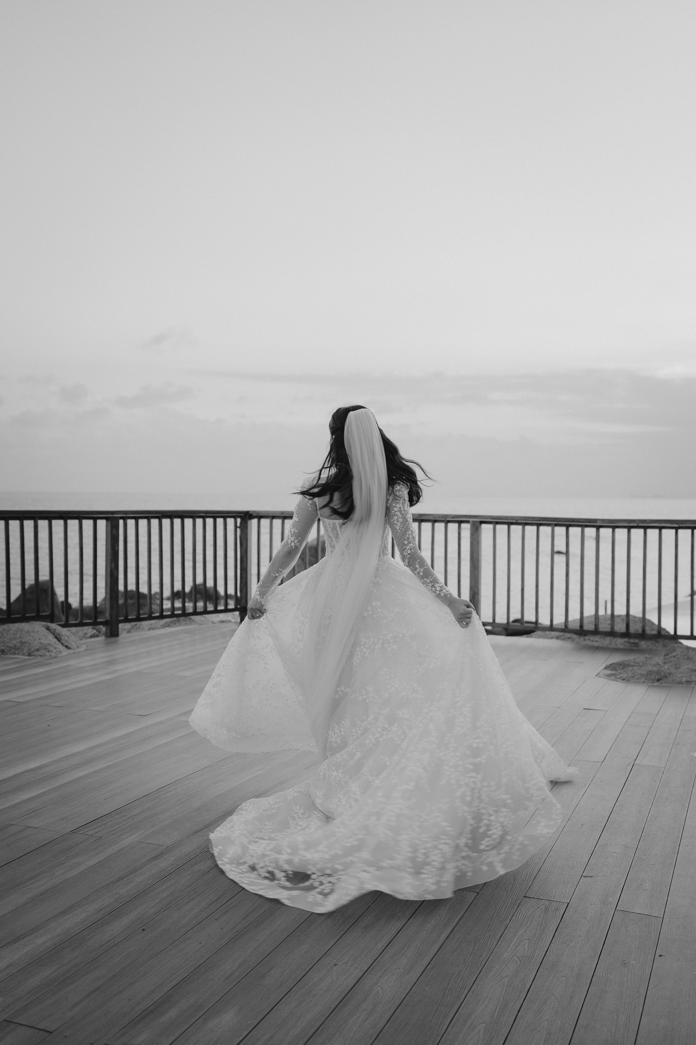 Hong Kong bride twirling her dress on the deck at Salavadee Resort & Spa, Koh Samui, Thailand. Wedding photography by Daniel Baci