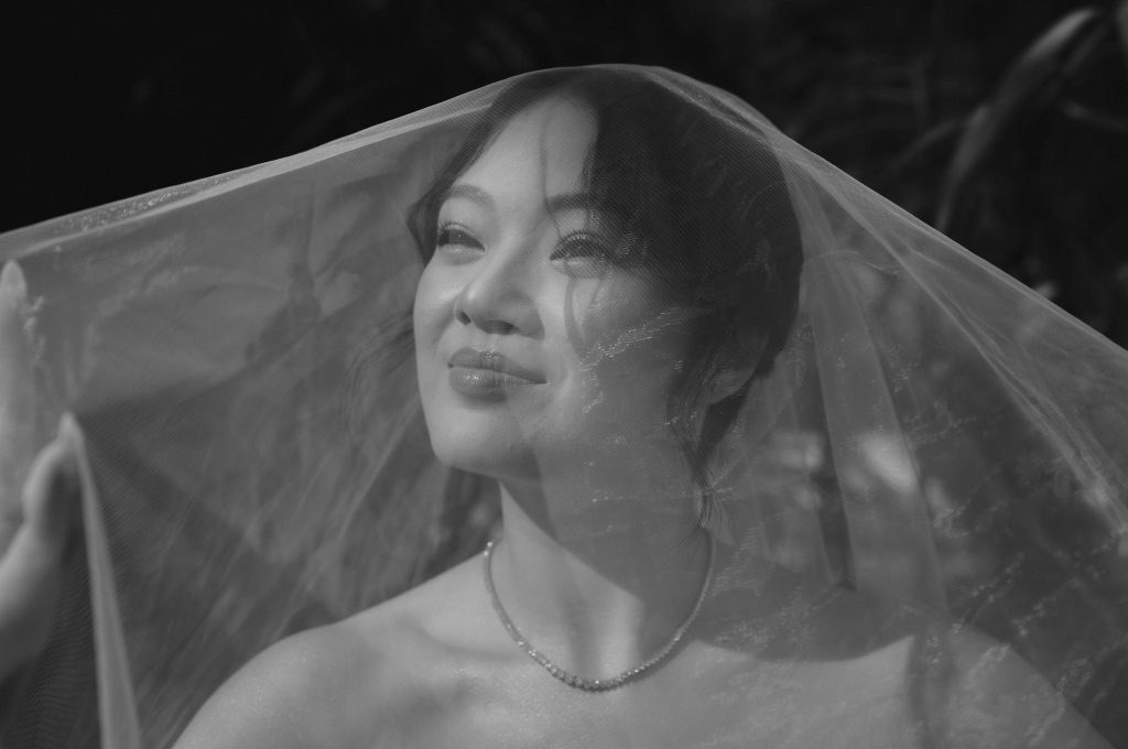 Bride from Hong Kong wedding portrait in Black and white with veil dropping over her head